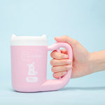 Cat paw being washed with a portable paw cleaning cup